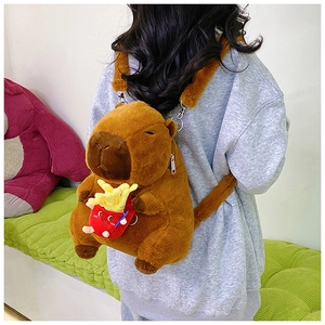 Detail showing plush capybara backpack with cute red fries pouch and adjustable straps