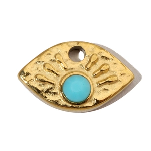 Detail of a golden evil eye pendant featuring a turquoise stone inlay on white background
