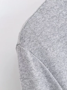Detailed macro view of the premium grey knit fabric and durable shoulder seam stitching