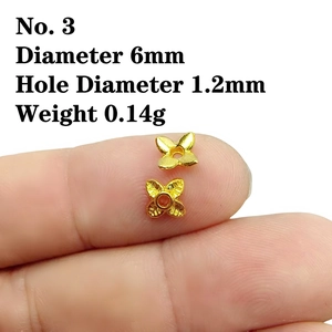 Detailed view of 6mm gold floral bead cap spacer for DIY jewelry making on fingertip