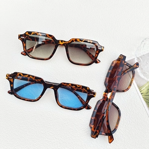 Detailed view of three vintage tortoiseshell square sunglasses with colored lenses