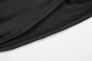 Close-up of double-stitched hem on black knitted mesh dress with refined texture