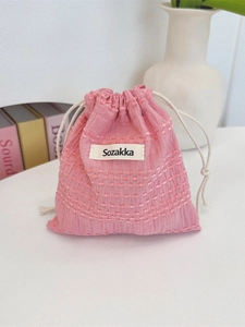 Pink drawstring storage bag with textured jacquard fabric and cotton rope closure