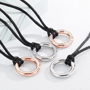Minimalist round titanium steel pendants in rose gold and silver on black velvet cords