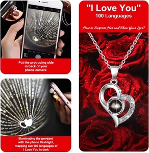 Macro detail of silver heart necklace showing how to use phone to project 100 languages