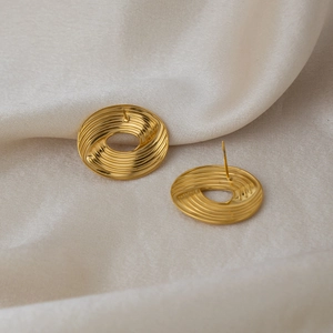 Polished 18K gold plated stainless steel stud earrings with spiral texture on silk