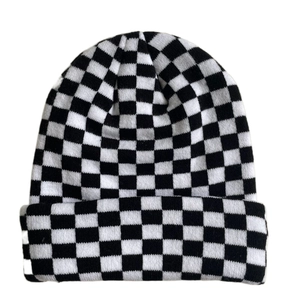 Close-up of black and white checkerboard knit beanie with soft textured fabric