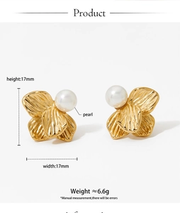 Detailed view of 17mm gold floral pearl earrings featuring fine textured metal petals