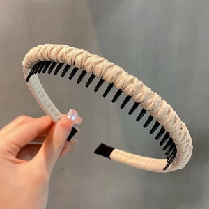 Detail of beige textured fabric headband with black anti-slip inner toothed comb structure