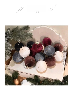 Close-up of 6cm velvet Christmas balls with gold star patterns and metal loops