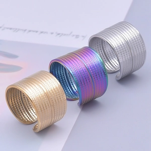 Three minimalist geometric braided rings in gold, rainbow, and silver stainless steel