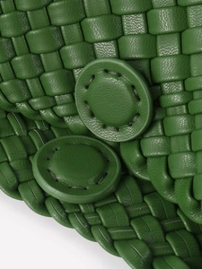 Green handmade woven leather handbag with intricate grid pattern and round buckles