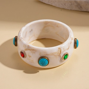 Detail of resin bangle with marble texture and colorful retro cabochon stones