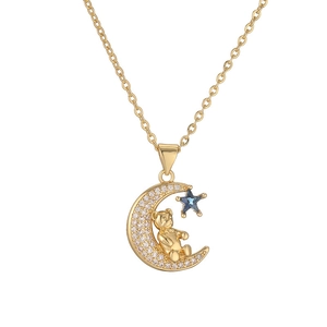 Detailed macro view of gold teddy bear on crystal crescent moon with blue star pendant