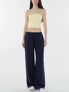 Detail of navy blue wide-leg trousers with soft drape and high-quality minimalist fabric