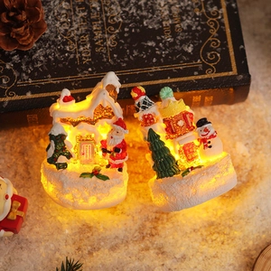 Glow Christmas resin figurines featuring Santa and snowman with warm LED lights and snow