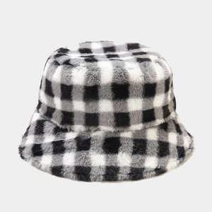 Detailed view of the thick plush faux fur texture on the black and white checkered bucket hat