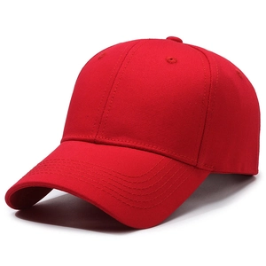 Minimalist red cotton baseball cap with structured crown and curved brim in side view