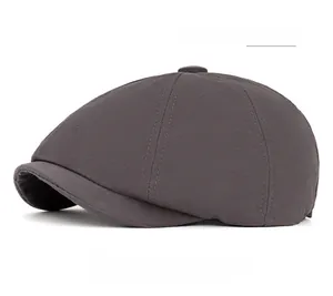 Detailed macro view of grey cotton newsboy hat fabric texture and top button detail