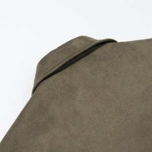 Macro detail of olive green lapel showing suede-like texture and fine stitching