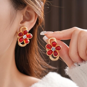 Vintage gold flower stud earrings with red glass petals and sparkling center crystals