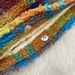 Detail of colorful plush plaid tote with soft lambskin texture and silver magnetic clasp
