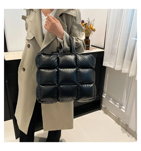 Vista dettagliata della borsa tote trapuntata nera con texture a quadretti imbottiti