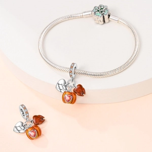 Detailed view of silver heart charm with give thanks engraving and autumn pumpkin bead