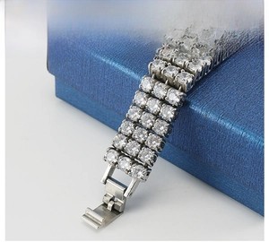 Detailed close-up of a silver-tone four-row diamond tennis bracelet with a secure folding clasp