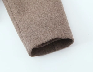 Detailed close-up showing the sleeve cuff and wool blend texture of camel short coat