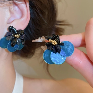 Detail showing vintage cluster stud earrings with tiger eye stone and blue petals