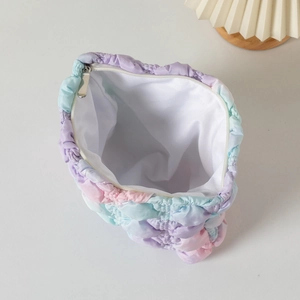 Top view of open quilted cloud bag with pastel gradient wash and silver zipper detail