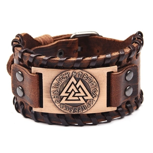Detail of a wide brown leather bracelet featuring an engraved Valknut symbol and runes