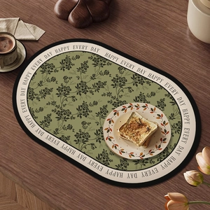 Waterproof leather oval placemat in sage green with floral texture on wooden table