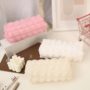 Large capacity puff texture pencil case in pink, white, and cream on an aesthetic desk