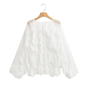 Detail of white ruffled chiffon blouse featuring layered frills and lantern sleeve cuffs