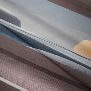 Close-up of bohemian wall tapestry showing stacked layers of multi-colored felt fabric
