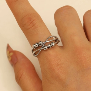 Silver fidget ring with double-layered crossover bands and movable beads for stress relief