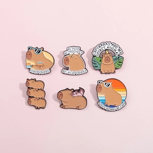 Set of 6 cute capybara enamel pins with various designs on a soft pink background