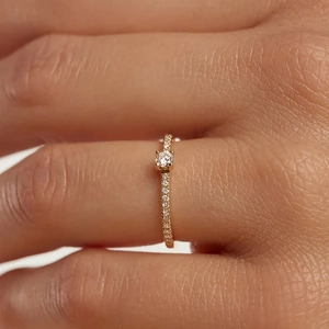 Detailed macro of S925 silver ring with pavé diamonds and minimalist center stone