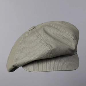 Detail shot of vintage olive newsboy cap showing durable twill texture and 8-panel stitch