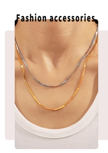 Detail of elegant gold and silver blade snake chains on neck with high metallic shine