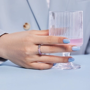Detail of s925 silver ring with pink and white rectangular cut zircons on model hand
