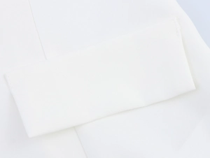 Close-up of white woven fabric texture and neat stitching on office suit set