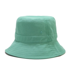 Close-up of mint green cotton bucket hat with stitching details and metal eyelets