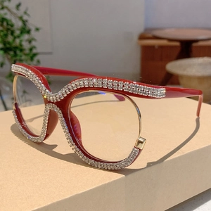 Macro shot of oversized red glasses frame with double row rhinestones and metal details