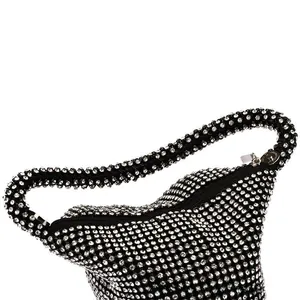 Close-up of black evening bag featuring sparkling rhinestones and silver zipper detail