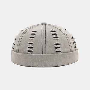 Distressed grey brimless docker hat with vintage ripped details in cotton canvas fabric