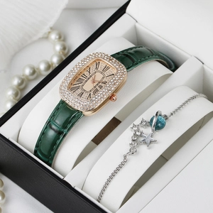 Close-up of luxury green quartz watch and planetary bracelet in a gift box