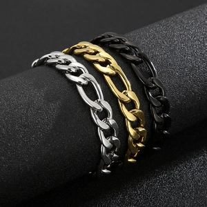 Detailed shot of Cuban link bracelets in silver, gold, and black steel finishes